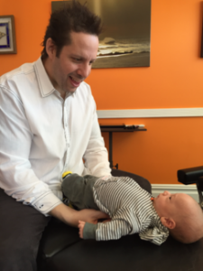 Dr. Josh adjusting a baby